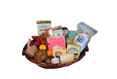 A close-up image of a custom gift basket filled with gourmet cheeses, crackers, chocolates, nuts, and more from 5280Gourmet.