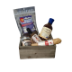 A wooden crate filled with a selection of spicy foods including ghost pepper salami, scorpion pepper chocolate, ghost salt, reaper miso, blueberry ghost barbecue sauce, and reaper hot sauce, all set against a rustic wooden background.