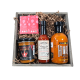 A rustic wooden crate filled with spicy gourmet items including Hot Reaper Miso, a Scorpion Chocolate Bar, Blonde Beard's hot sauce, and Redlaw Trinidad Scorpion Hot Sauce